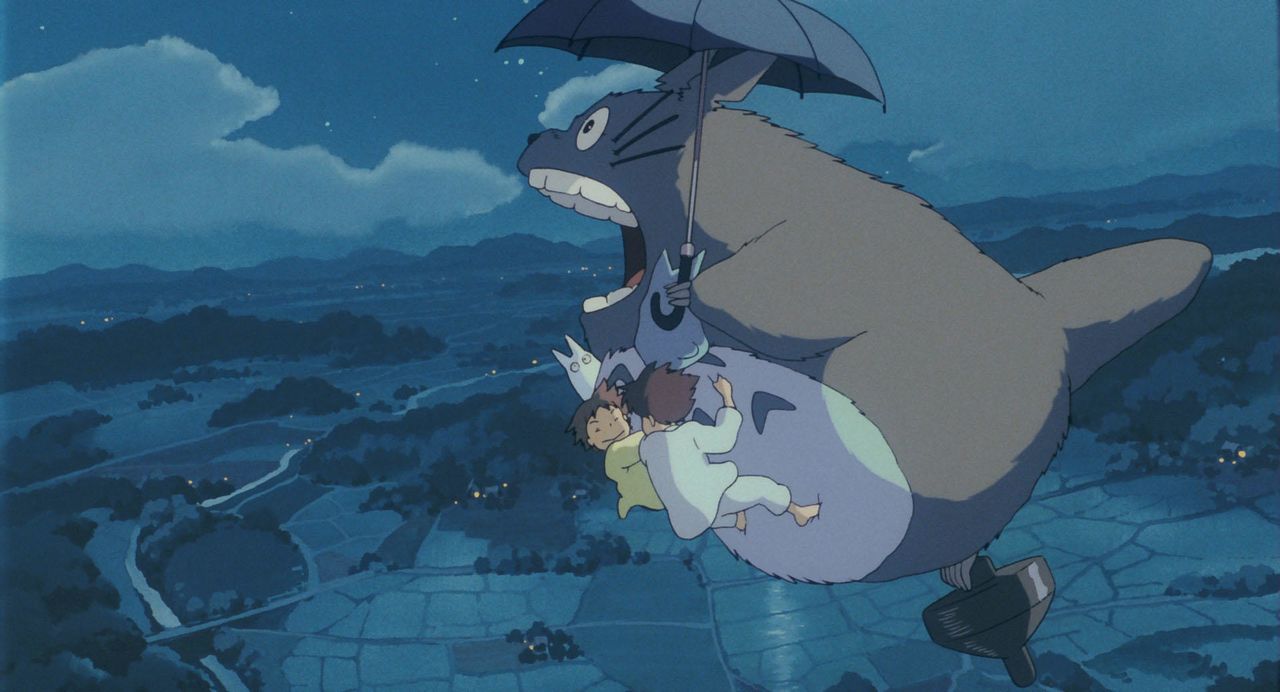 Totoro emmène Satsuki et Mei dans les airs dans Mon voisin Totoro. (© 1988 Studio Ghibli)