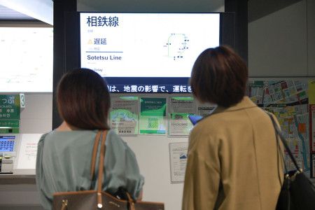地震影響下確認電車運行狀態的客人們＝7日下午、東京・JR有樂町站
