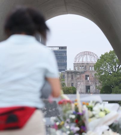 迎接第75回的廣島原爆紀念日，低頭祈求的女性。後方為廣島原爆紀念館（8月6日上午於廣島市中區的和平紀念公園）