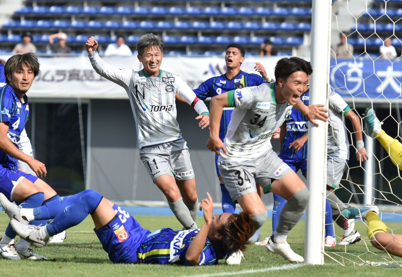 ラインメール青森−アトレチコ鈴鹿戦でプレーするカズ選手(中央)=2024年9月16日、青森・カクヒログループアスレチックスタジアム(時事)