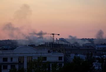 ロシアが併合したウクライナ東部ドネツクの建物から上がる煙＝10日（ロイター＝共同）