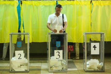 ウクライナ最高会議選挙で投票する男性＝2019年7月、キーウ（ゲッティ＝共同）