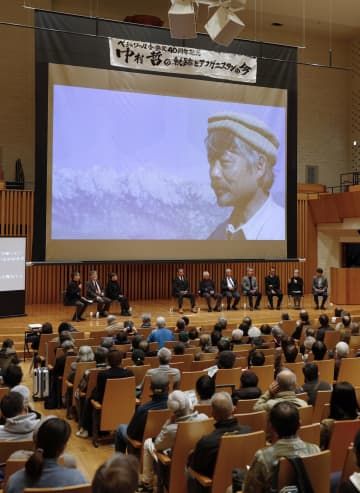 福岡市で開かれた「ペシャワール会」設立40周年の記念行事。スクリーンには故・中村哲さんの姿が映し出された＝18日午後