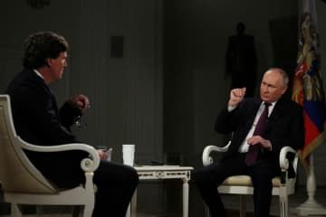 タッカー・カールソン氏（左）のインタビューに応じるロシアのプーチン大統領＝6日、モスクワ（ロイター＝共同）