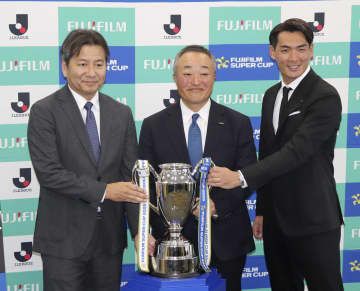 富士フイルム・スーパーカップの開催概要発表会見で、記念撮影に応じるJリーグの野々村芳和チェアマン(左)ら=30日午後、東京都千代田区
