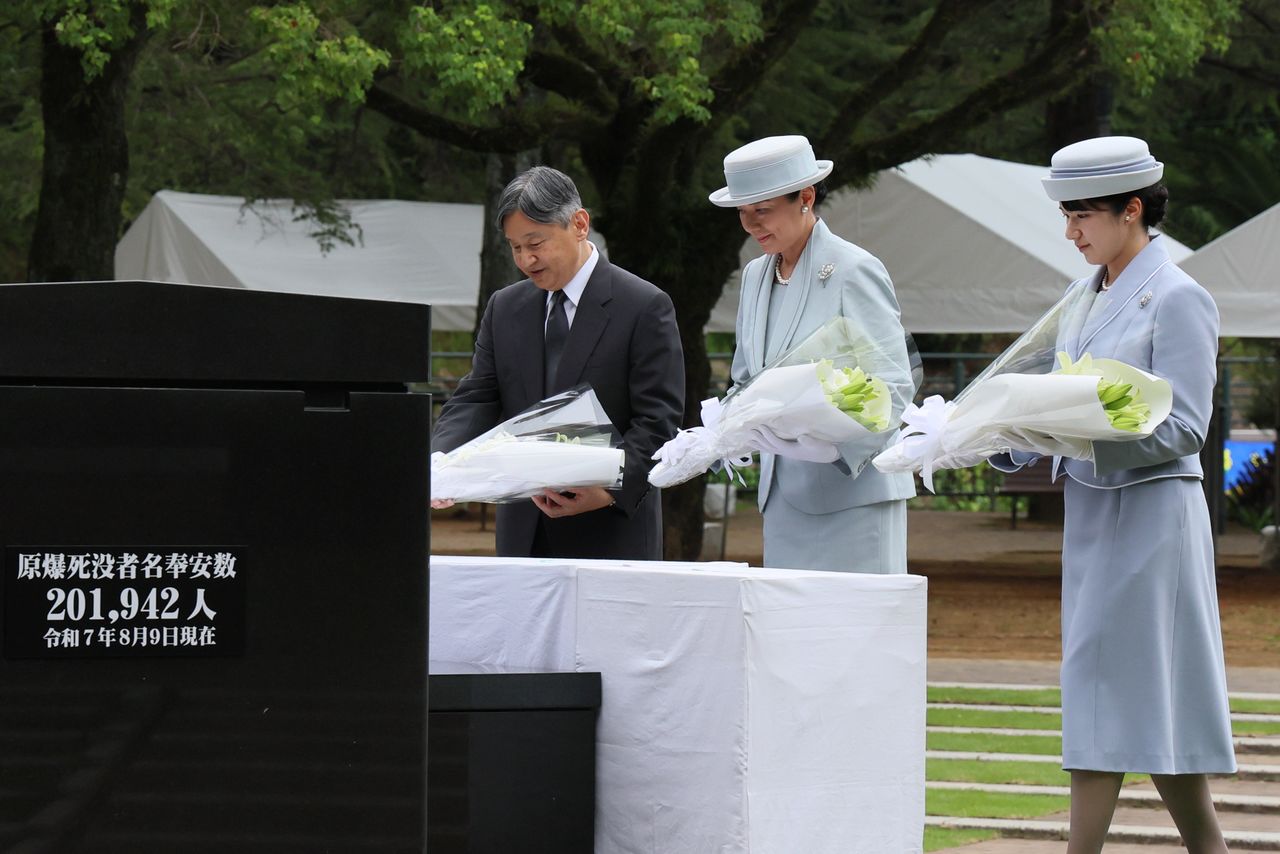 長崎市の平和公園を訪れ、原爆落下中心地碑に供花される天皇、皇后両陛下と長女愛子さま(時事)