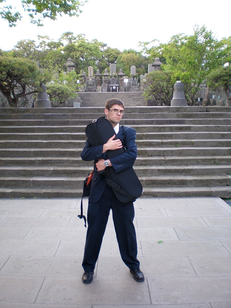 鹿児島県にある西郷隆盛の墓の前でバイオリンを抱きかかえるチャド・キャノン＝2007年（チャド・キャノン提供）