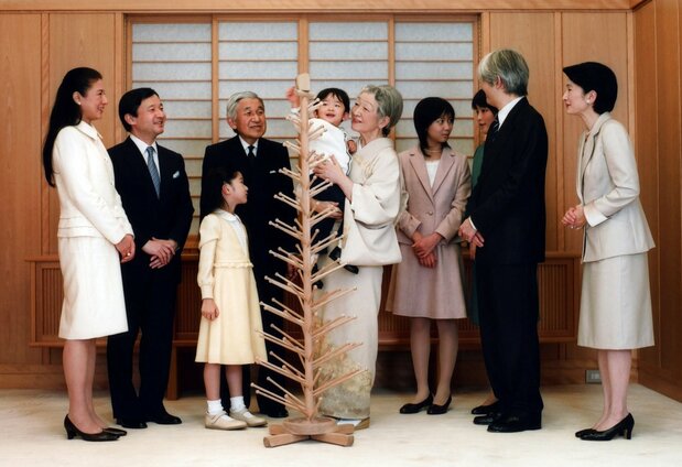 Empress Michiko holds her grandson Prince Hisahito as the imperial family gathers for a New Year photo in 2009. (© Kurita Kaku/Gamma-Rapho via Getty Images)
