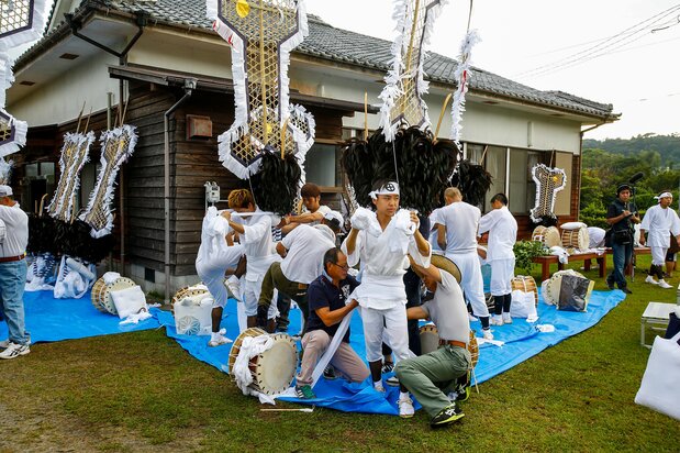 集会所に集まり、数人がかりで太鼓と飾りをつける