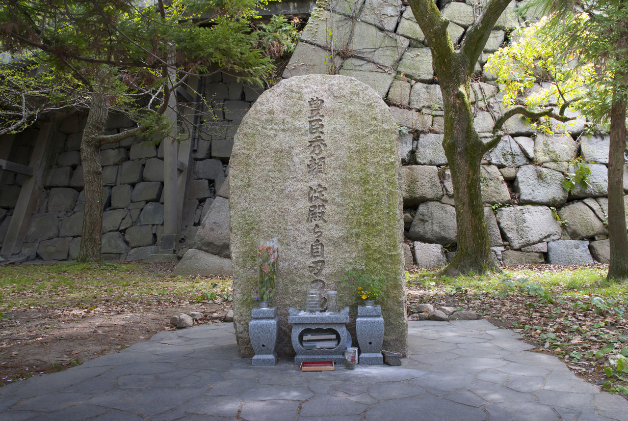 Каменный памятник Тоётоми Хидэёри и Ёдо-доно перед каменным основанием замка