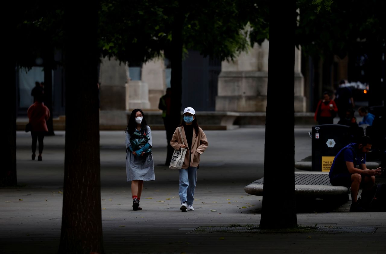 People wear protective masks as they walk through the city centre, amid the outbreak of the coronavirus disease (COVID-19) in Manchester, Britain, June 21, 2021. REUTERS/Phil Noble