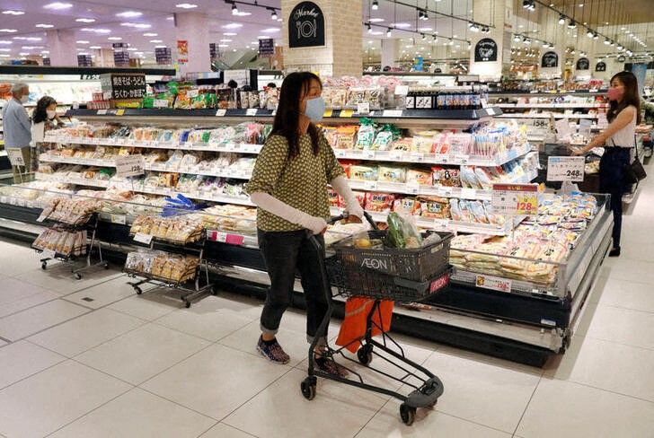 A shopper wearing a protective mask pushes a shopping cart at Japan