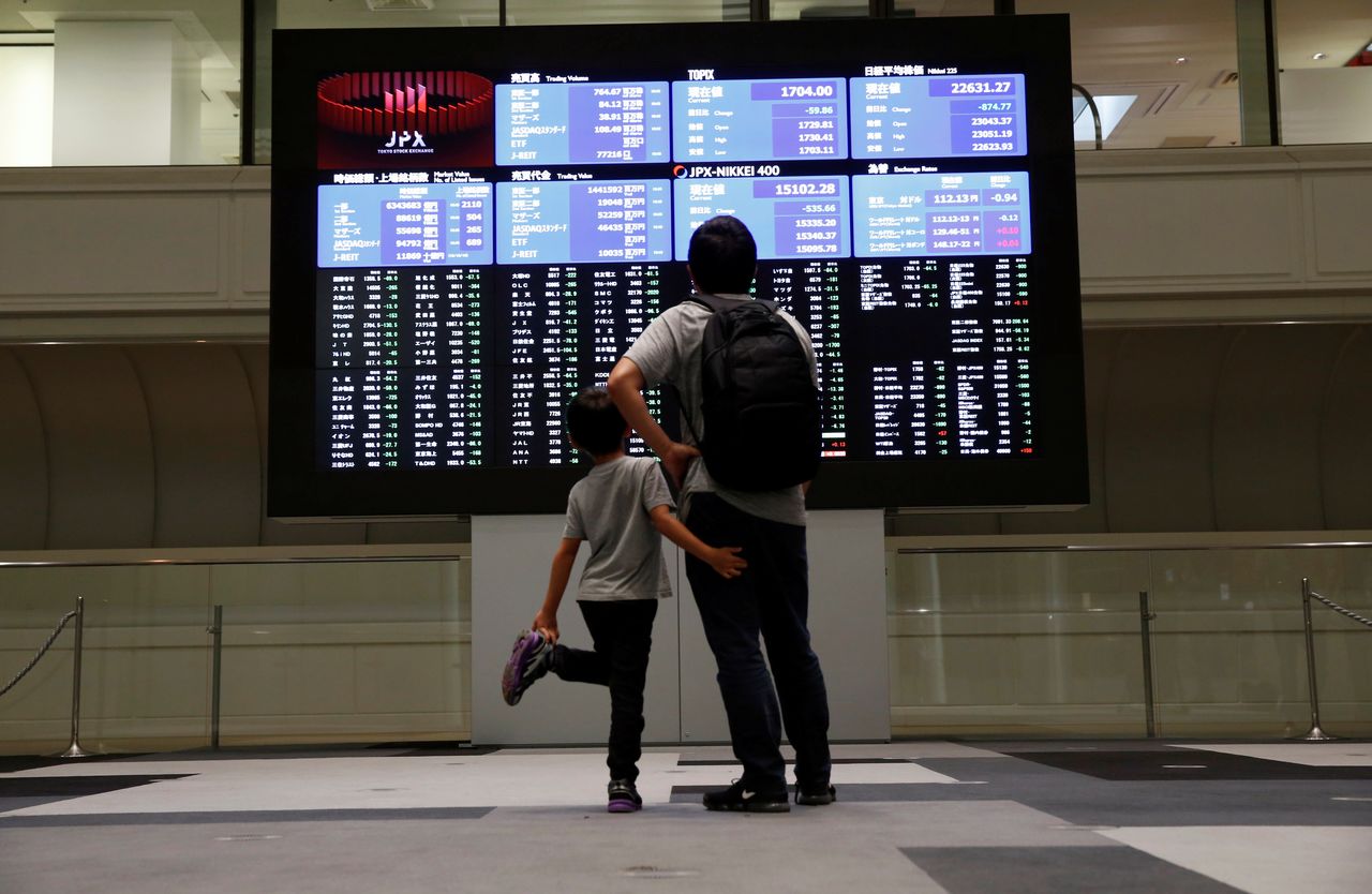 Visitors look at a stock quotation board at Tokyo Stock Exchange in Tokyo Japan, October 11, 2018. REUTERS/Issei Kato
