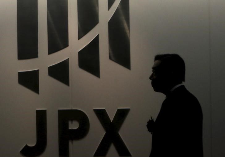 A man walks past the logo of Japan Exchange Group Inc. at the Tokyo Stock Exchange (TSE) in Tokyo August 26, 2015. Asian stocks fell on Wednesday as investors feared fresh rate cuts in China would not be enough to stabilize its cooling economy or halt a collapse in its stock markets. REUTERS/Yuya Shino