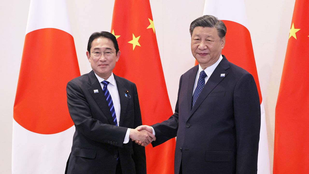 Рукопожатие премьер-министра Японии Кисиды Фумио (слева) и председателя КНР Си Цзиньпина, город Сан-Франциско (© Reuters)