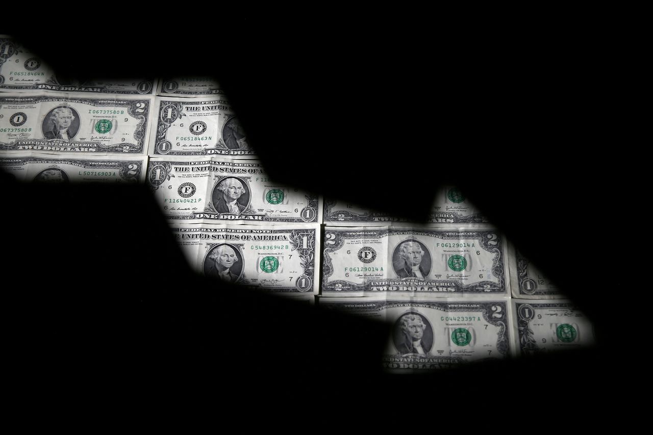 FILE PHOTO: U.S. dollar banknotes are seen through a printed stock graph in this illustration taken February 7, 2018. REUTERS/Dado Ruvic/Illustration/File Photo