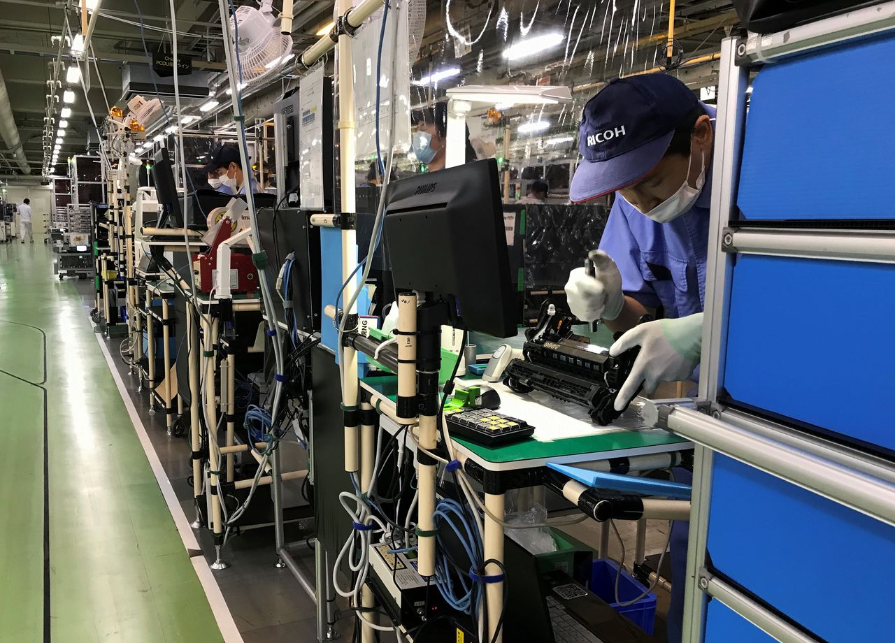 A Ricoh employee checks a drum unit on the production line at the company?fs printer components factory in Atsugi, Kanagawa prefecture, Japan July 13, 2020. Picture taken July 13, 2020.  REUTERS/Naomi Tajitsu