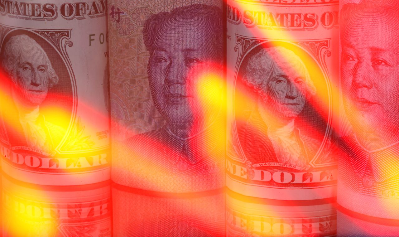 Chinese Yuan and U.S. dollar banknotes are seen behind illuminated stock graph in this illustration taken February 10, 2020. REUTERS/Dado Ruvic/Illustration