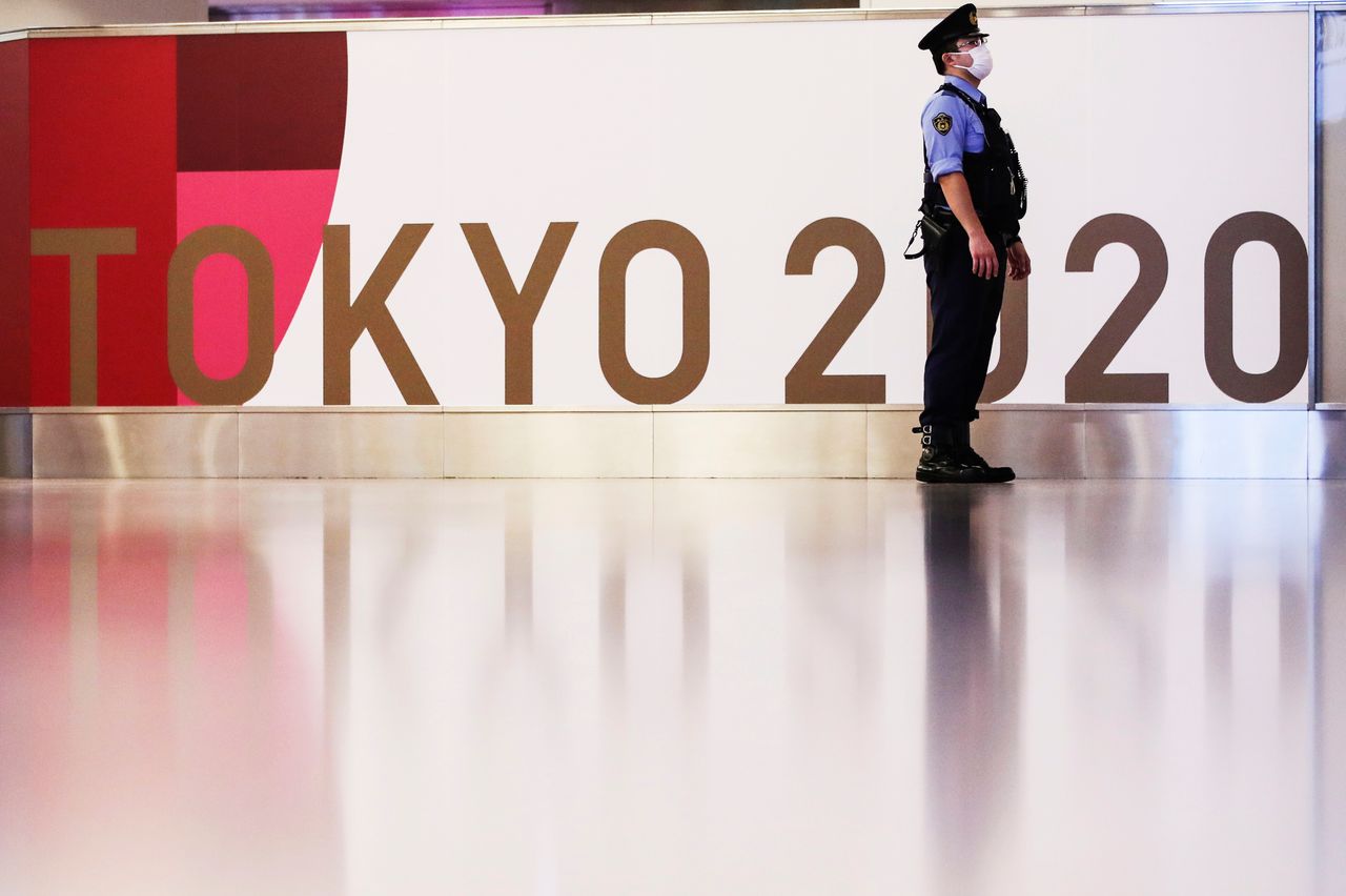 A police officer stands guard before the arrival of International Olympic Committee (IOC) President Thomas Bach at Haneda Airport ahead of Tokyo 2020 Olympic Games, in Tokyo, Japan July 8, 2021. REUTERS/Kim Kyung-Hoon