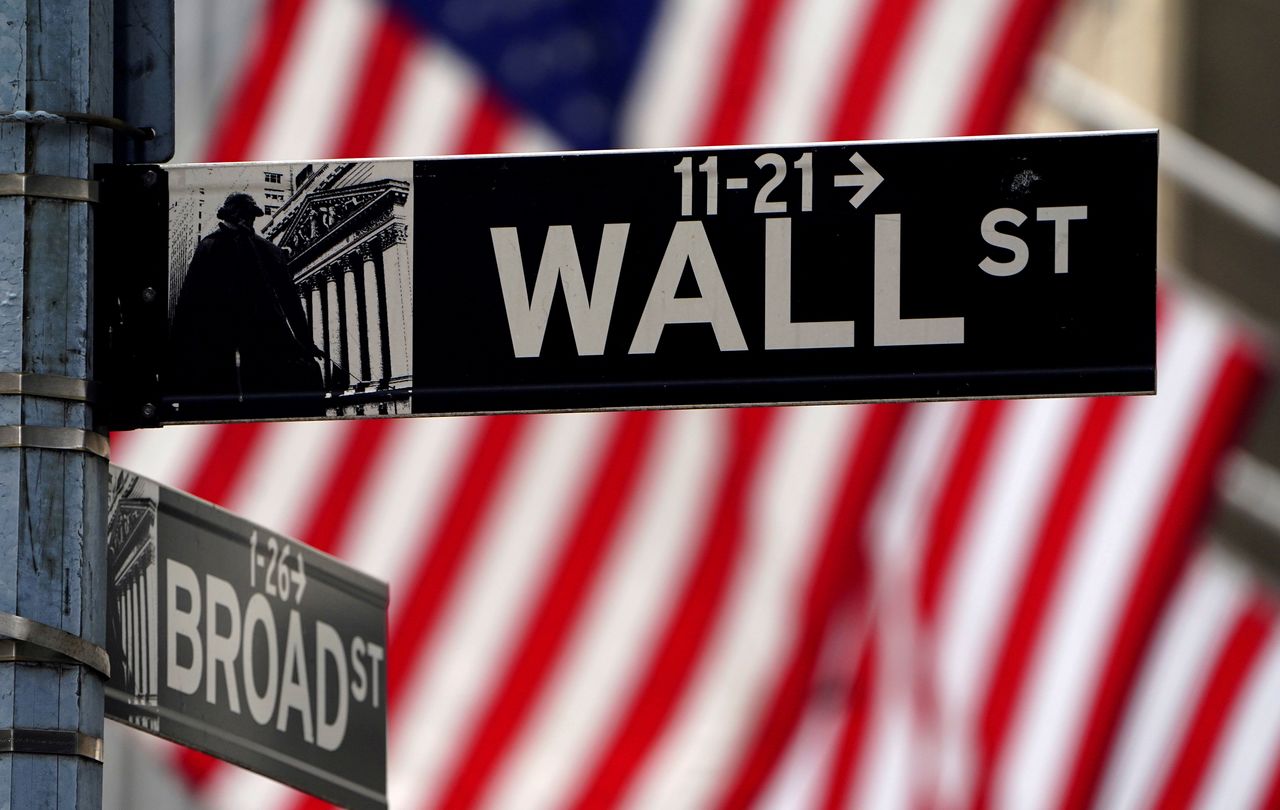 FILE PHOTO: A Wall Street sign is pictured outside the New York Stock Exchange amid the coronavirus disease (COVID-19) pandemic in the Manhattan borough of New York City, New York, U.S., April 16, 2021. REUTERS/Carlo Allegri