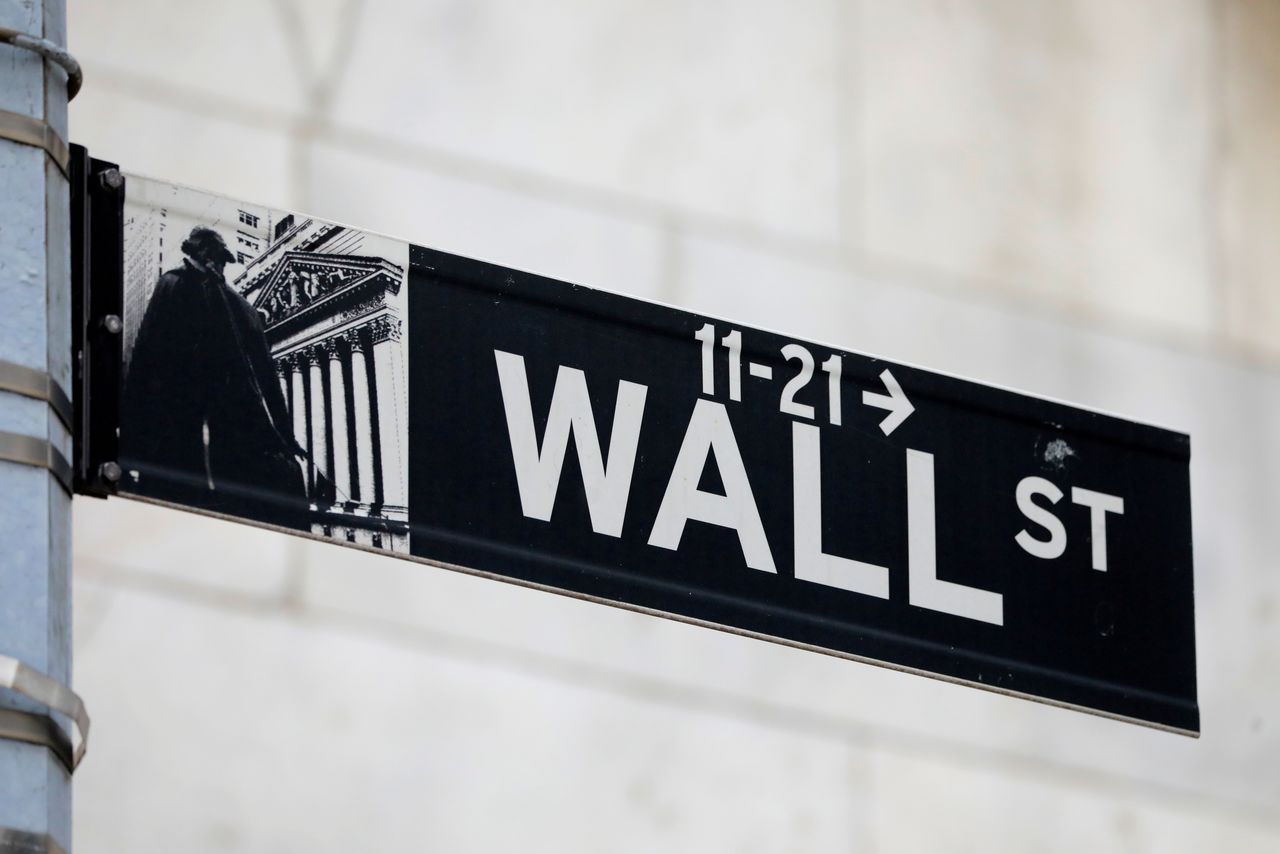 FILE PHOTO: A street sign for Wall Street is seen outside of the New York Stock Exchange (NYSE) in New York City, New York, U.S., June 28, 2021. REUTERS/Andrew Kelly/File Photo