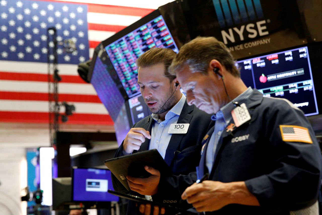 FILE PHOTO: Traders work on the floor of the New York Stock Exchange (NYSE) in New York City, U.S., July 12, 2021.  REUTERS/Brendan McDermid/File Photo